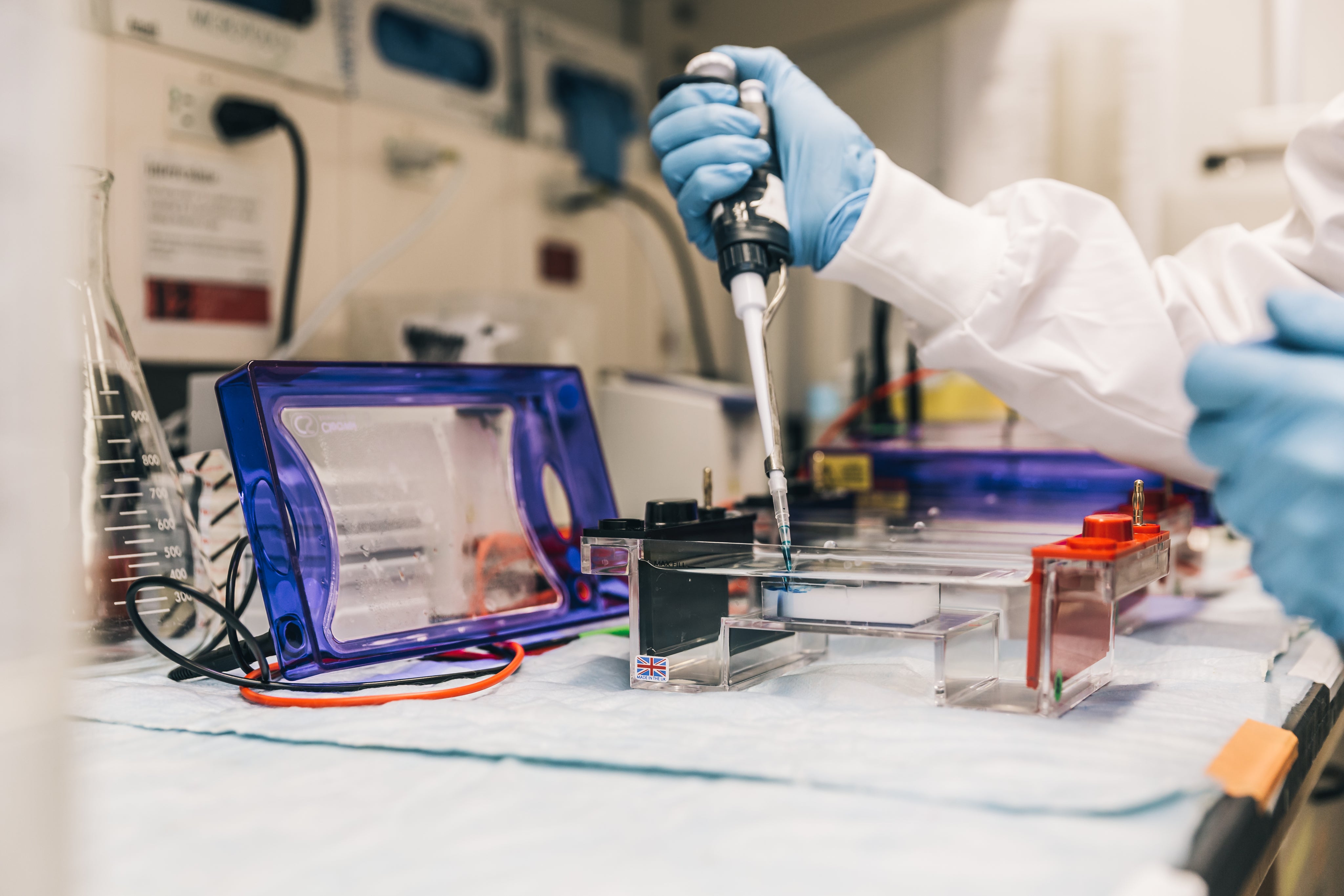 scientist-in-lab-with-pipette - UNITED POWERSYS-Motive Power Battery Solutions